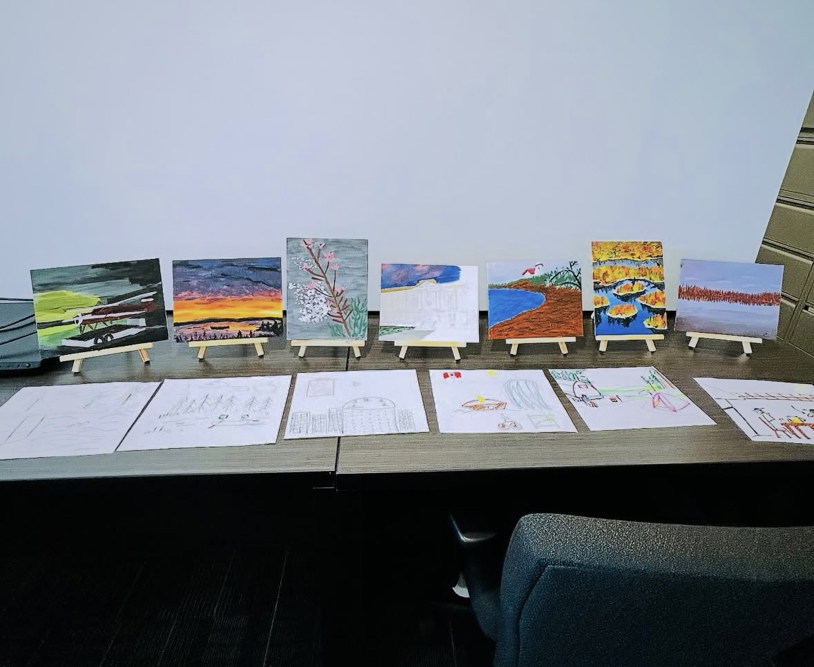 Array of paintings perched on small easels created during Employee Appreciation Day.