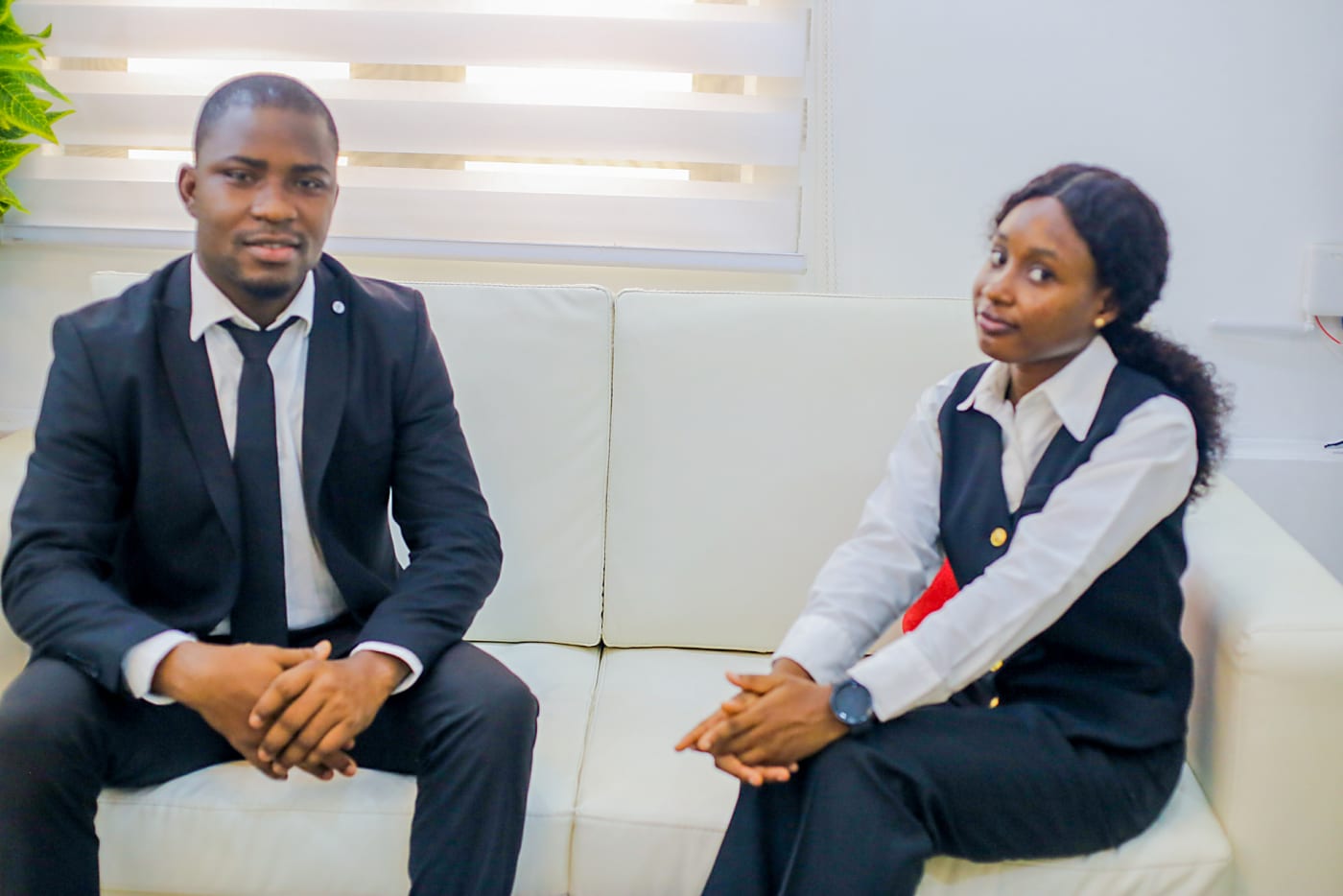 Two members of the firm seated in the office