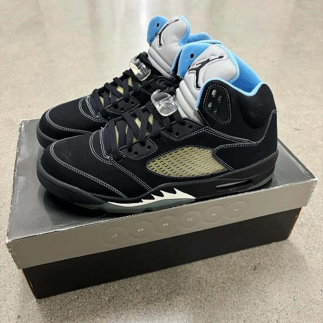 Air Jordan 5 Black University Blue 2026 medial view showing translucent mesh panels and University Blue interior lining