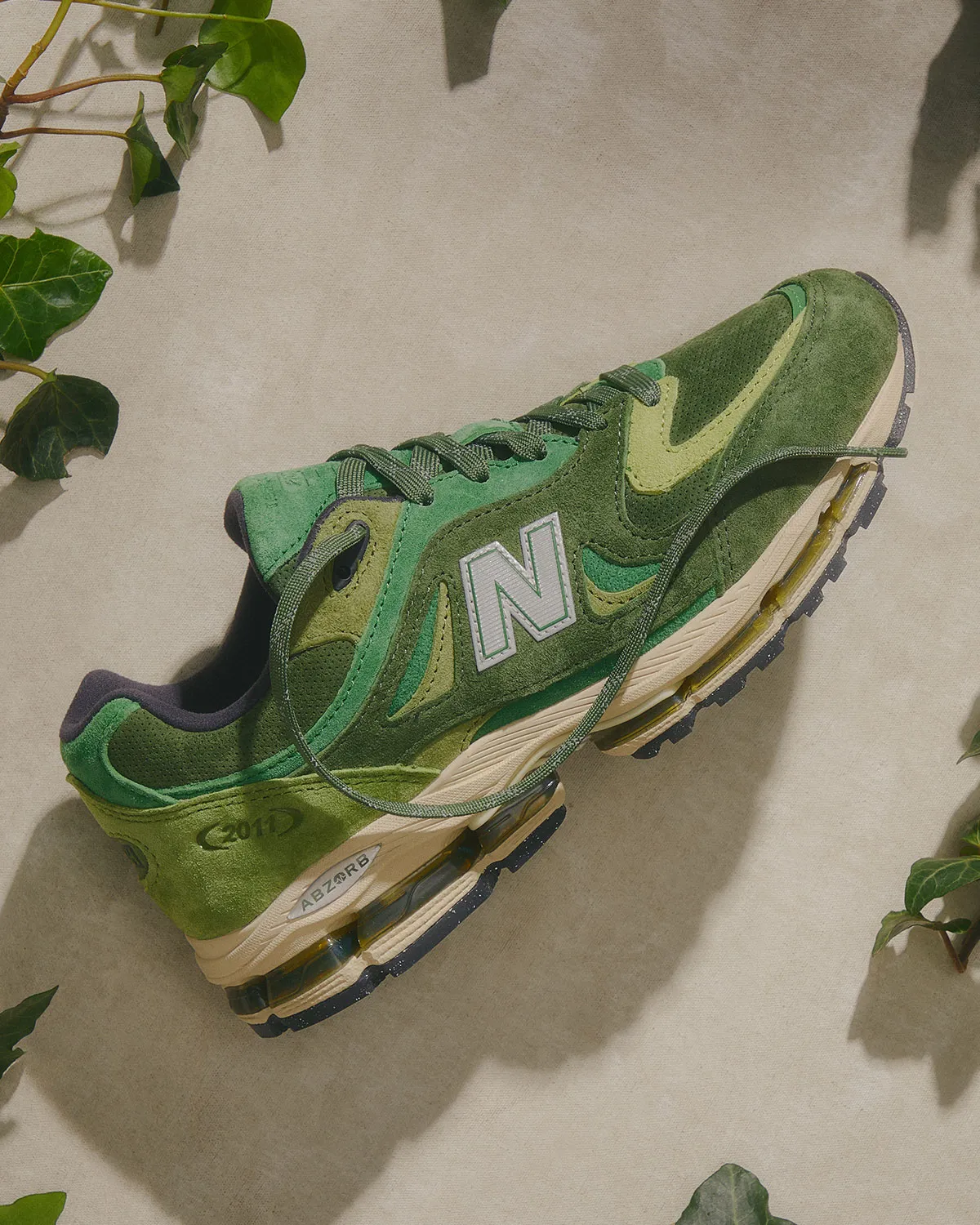 Kith x New Balance 2011 Leaf Green colourway layered suede leather mesh upper lateral 2026