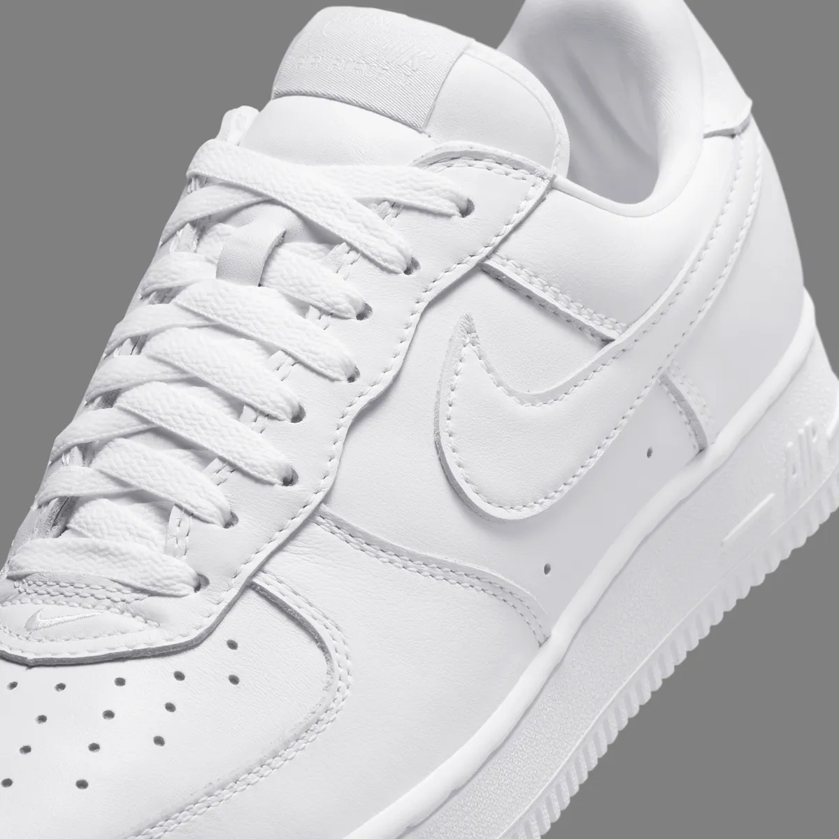 Nike Air Force 1 Low '01 Triple White IV4501-100 top-down view showing the stitched toe Swoosh and leather tongue