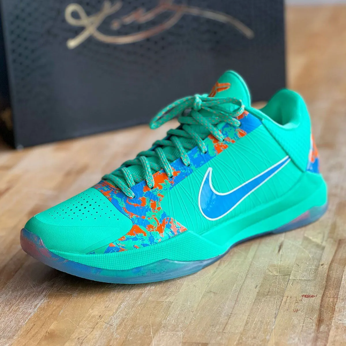 Jalen Brunson Nike Kobe 5 Protro NY vs NY shoe in Menta green with blue and orange splatter detailing on translucent outsole