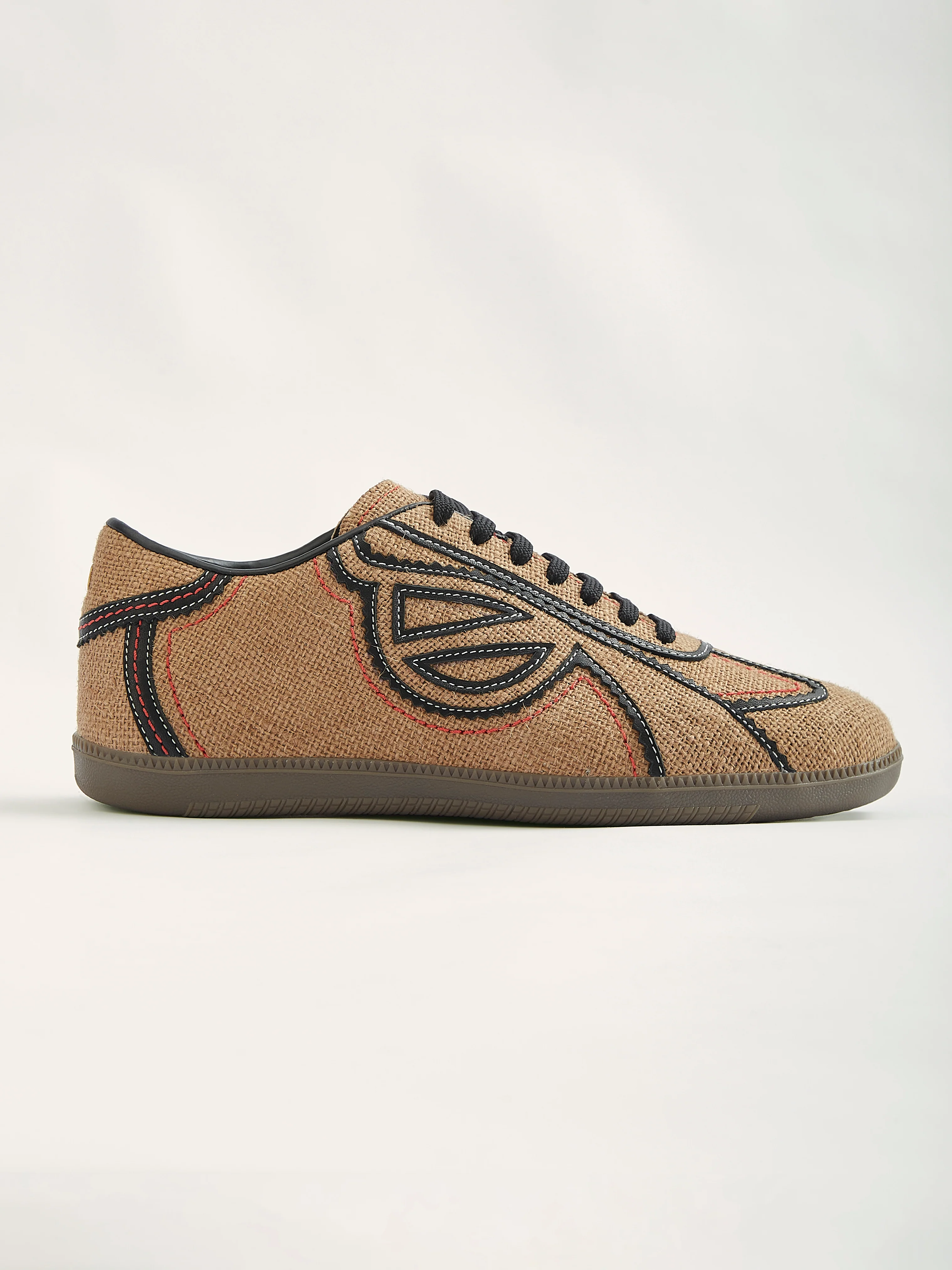 Ikat-pattern sneaker with black leather trim and tribal motif detailing from an Indian artisan sneaker studio
