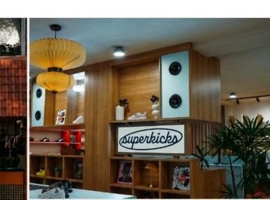 Superkicks GK-II store interior with vinyl listening station, sound bar, and wooden display shelving