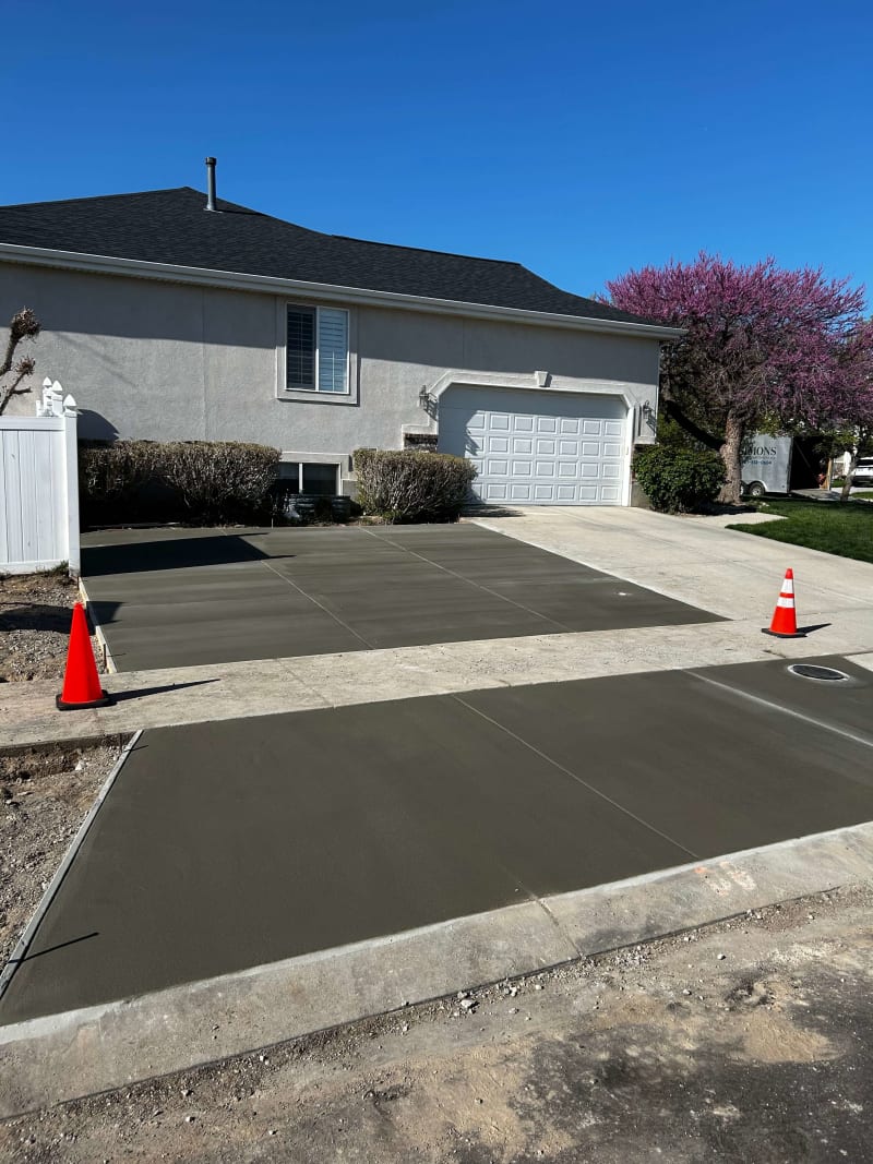 Fresh concrete driveway in front of a residential garage