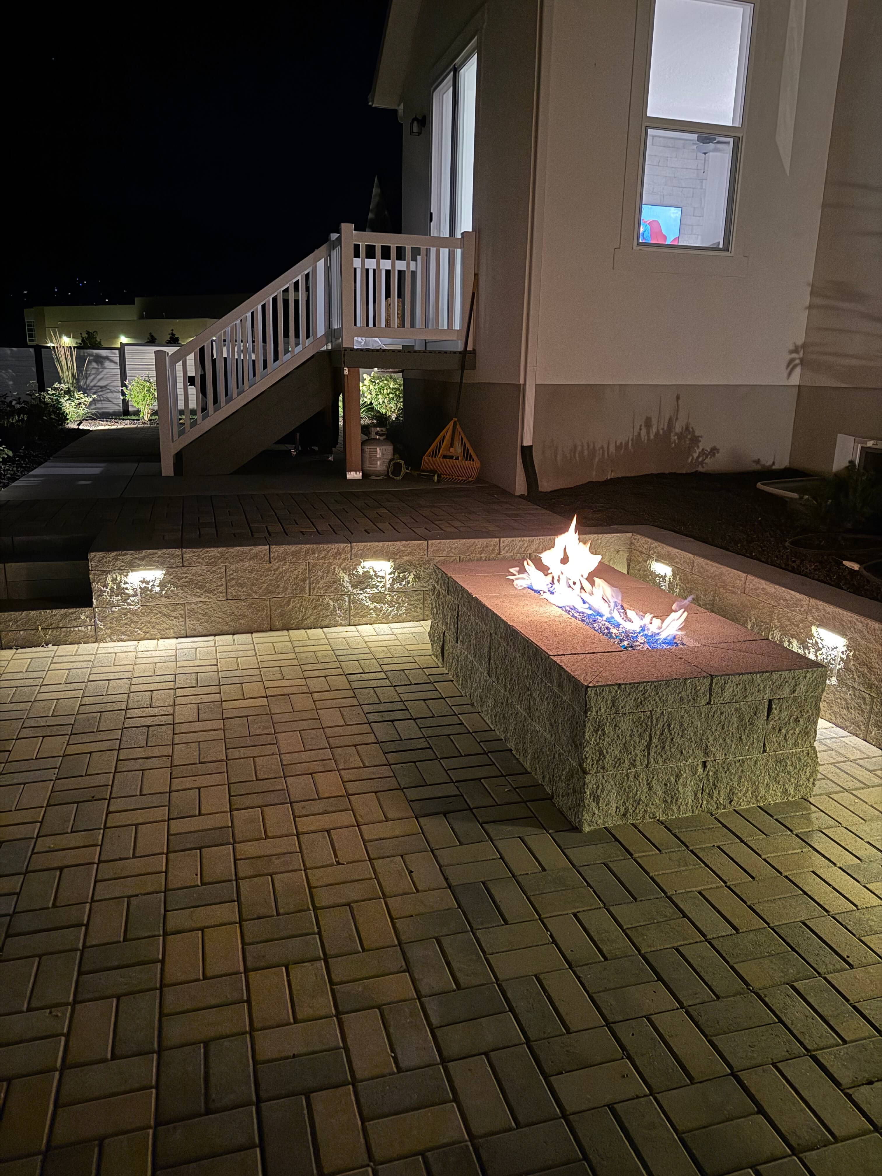 Fire pit and paver patio at night