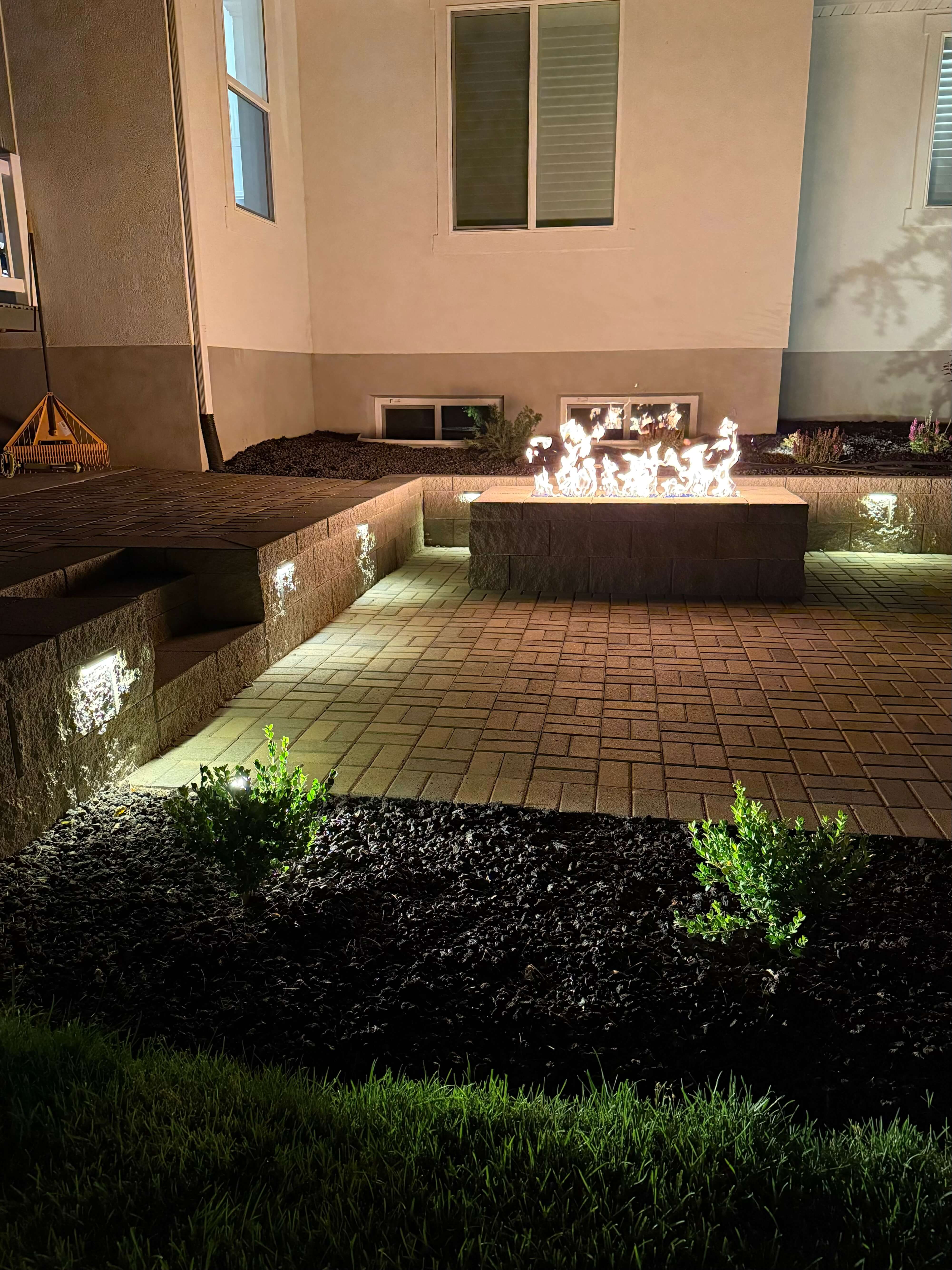Night patio with fire pit and lighting