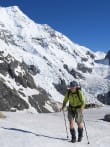 Alpine Treks & Hikes feature image - Trekker on Ball Ridge in front of Caroline Face