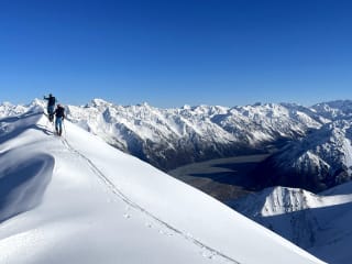 Getting there feature image - Ski tourers on the ridge above Erewhon Hut overlooking the Rangitata River