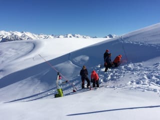 Why Choose Our Backcountry Training? feature image - Avalanche safety and backcountry skills courses - digging snow pits to investigate the snowpack