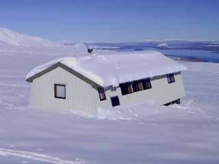 Heated Private Huts feature image - Rex Simpson Hut in winter. A spectacular location in the Two Thumb Range, overlooking the turquoise blue of Lake Tekapo. Stunning star-gazing on a clear night.