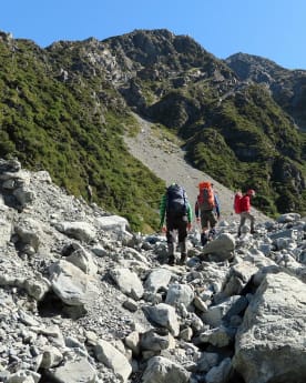 Preparing for your Mountain Adventure - Routes to and from Caroline Hut and Ball Ridge - Hikers navigating large boulders while crossing Husky Stream washout, Ball Pass