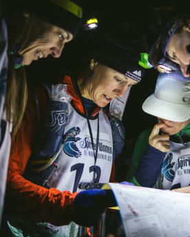 Preparing for your Mountain Adventure - Navigation Training for Spirited Women Adventure Race - Spirited Women Adventure Race competitors studying the map and planning their navigation before the start of the event