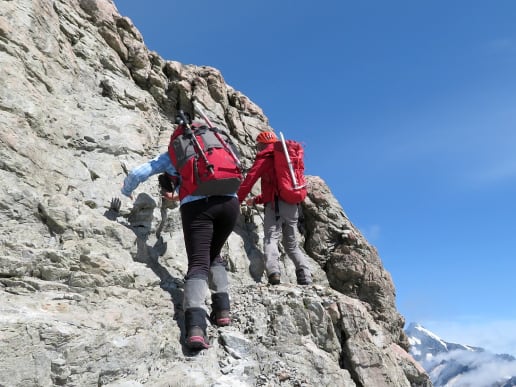 About - Preparing for your Mountain Adventure - Routes to and from Caroline Hut and Ball Ridge - Scrambling up a steep rocky section to Kaitiaki Peak above Ball Pass - Mountain hiker climbing up steep and exposed rocky ground near Ball Pass, Aoraki Mount Cook National Park 12