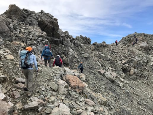About - Preparing for your Mountain Adventure - Routes to and from Caroline Hut and Ball Ridge - Crossing a steep, rocky section of Ball Ridge near Ball Pass - Hikers crossing steep rocky terrain and scree, Ball Ridge, Ball Pass, Aoraki Mount Cook National Park 8