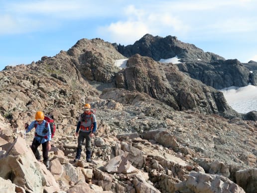 About - Preparing for your Mountain Adventure - Routes to and from Caroline Hut and Ball Ridge - Boulder fields on Ball Ridge near Ball Pass - Hikers moving through a boulder field on Ball Ridge, Aoraki Mount Cook National Park 9