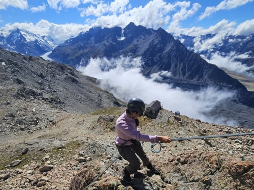 New Zealand Alpine Instruction Courses - Mountaineering & Climbing Instruction Courses - Introductory Mountaineering Course - Mountaineering Skills Instruction - abseiling on rock above Caroline Hut, Tasman Valley, Aoraki Mount Cook National Park - Climber abseiling down a rope above a mountain hut in Aoraki Mount Cook National Park, New Zealand 7