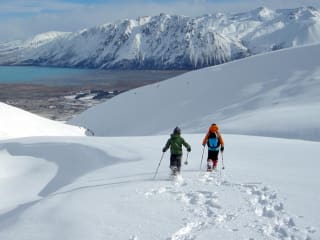Why Snowshoeing in the Mackenzie Country? feature image - Snowshoeing in the Two Thumb Range, overlooking the turquoise blue of Lake Tekapo.