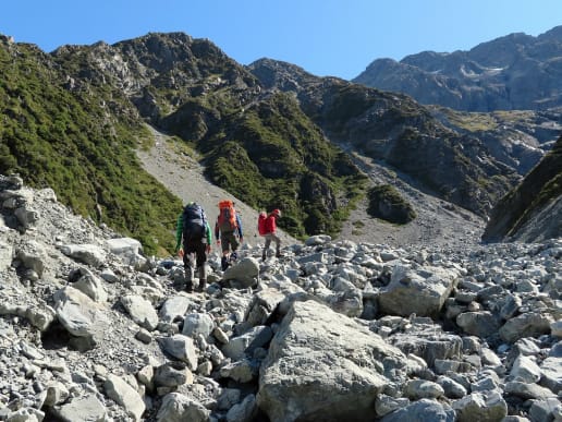 About - Preparing for your Mountain Adventure - Routes to and from Caroline Hut and Ball Ridge - Crossing Husky Stream, Ball Pass, Aoraki Mount Cook National Park - Hikers navigating large boulders while crossing Husky Stream washout, Ball Pass 1