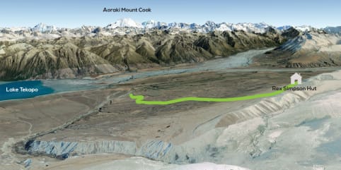 Tekapo High Country Hike - 1.5 Day Hike - The image depicts a vast, rugged landscape with snow-capped mountains in the background, a glacial lake in the foreground, and a hiking trail winding through the valley. 1