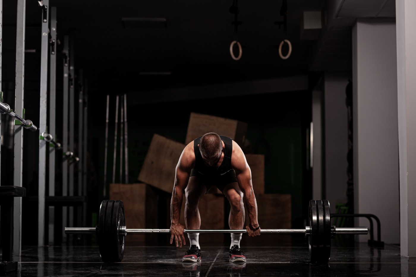 Athlete lifting a loaded barbell in a strength gym
