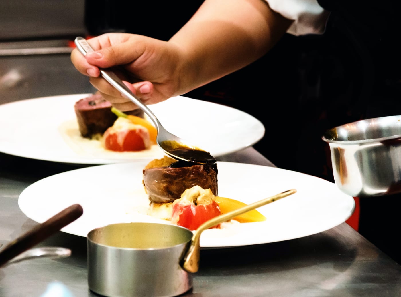 Chef plating a dish in the ELDR open kitchen