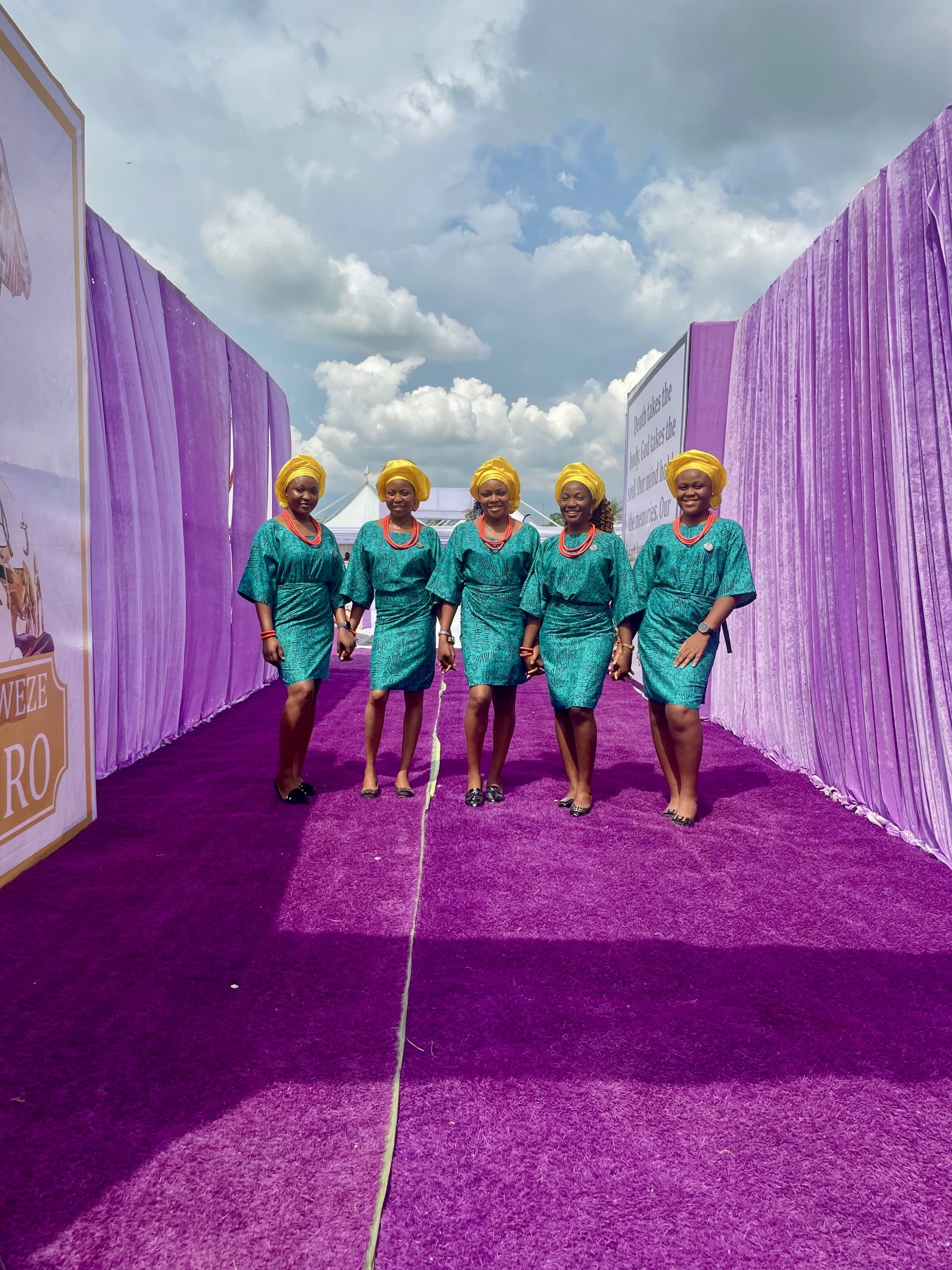 Ushers in teal Ankara on purple carpet