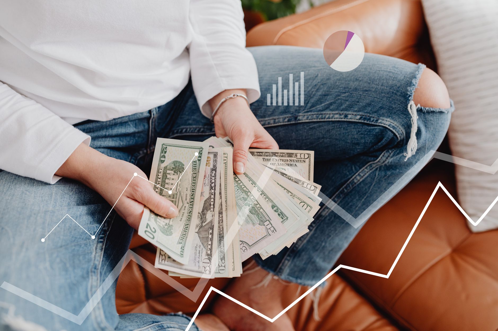 Person with dollars in hand, sitting, financial graphics overlay showing growth.