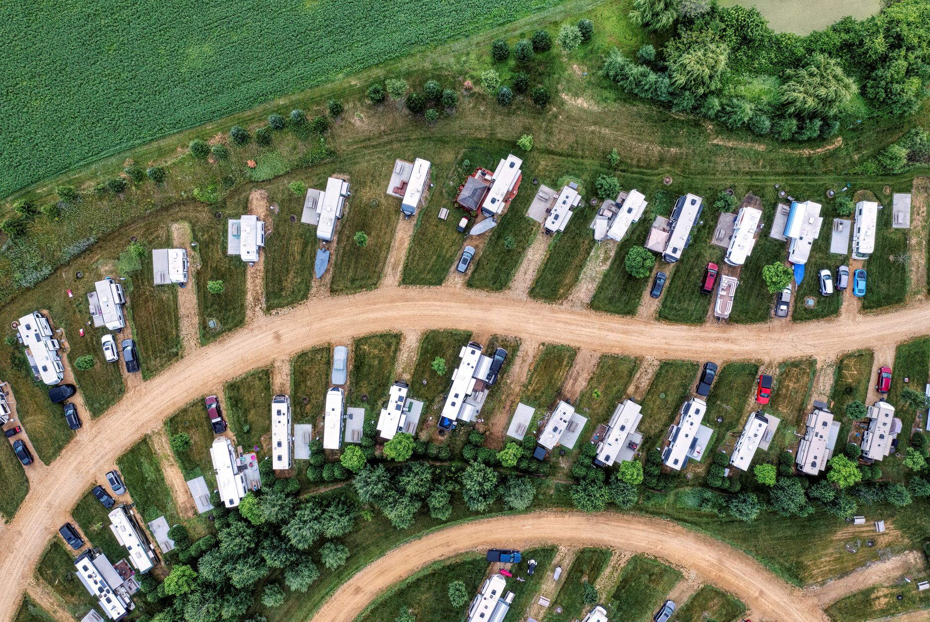 Top-down drone shot of campervans parked in a lush green camping site in Nelson, Wisconsin.
