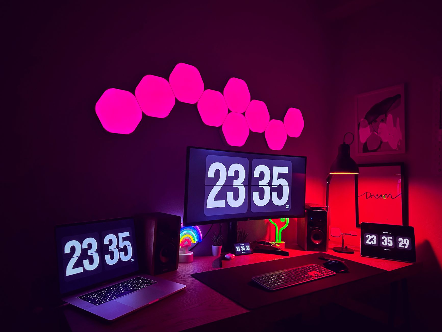 A stylish modern workspace featuring multiple screens, neon lights, and digital clocks.