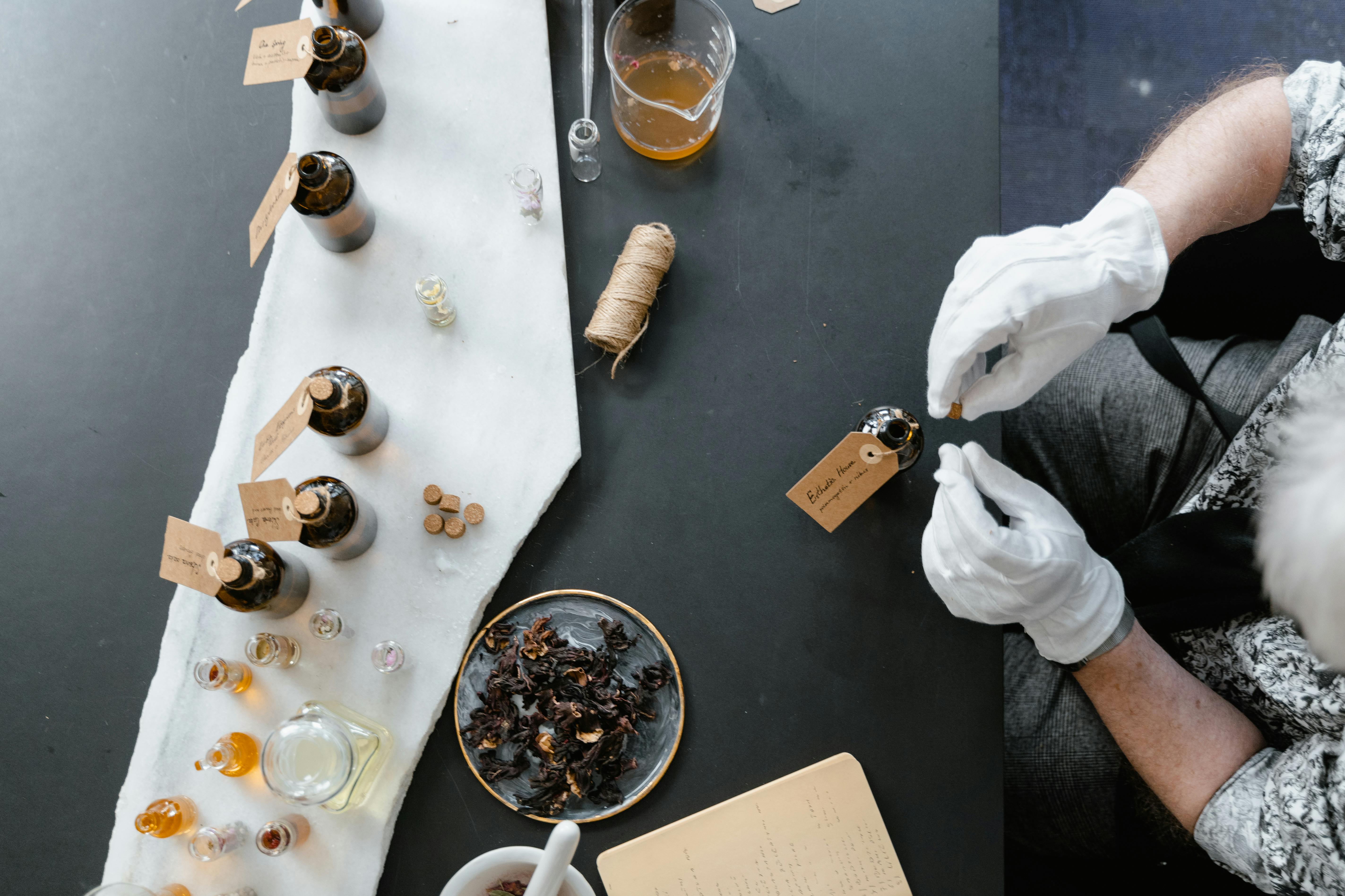 Master Perfumers blending ingredients with precision drop