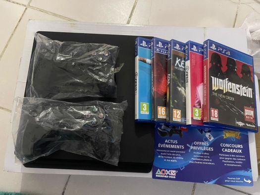 PlayStation 4, imported from England, with 2 controllers and 5 games