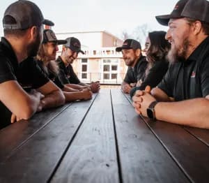 Precision Plumbing & Septic team in Georgia standing in front of service trucks