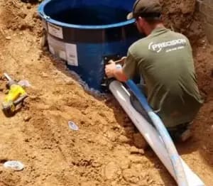 Technician performing septic tank pumping service in Georgia for Precision Plumbing & Septic