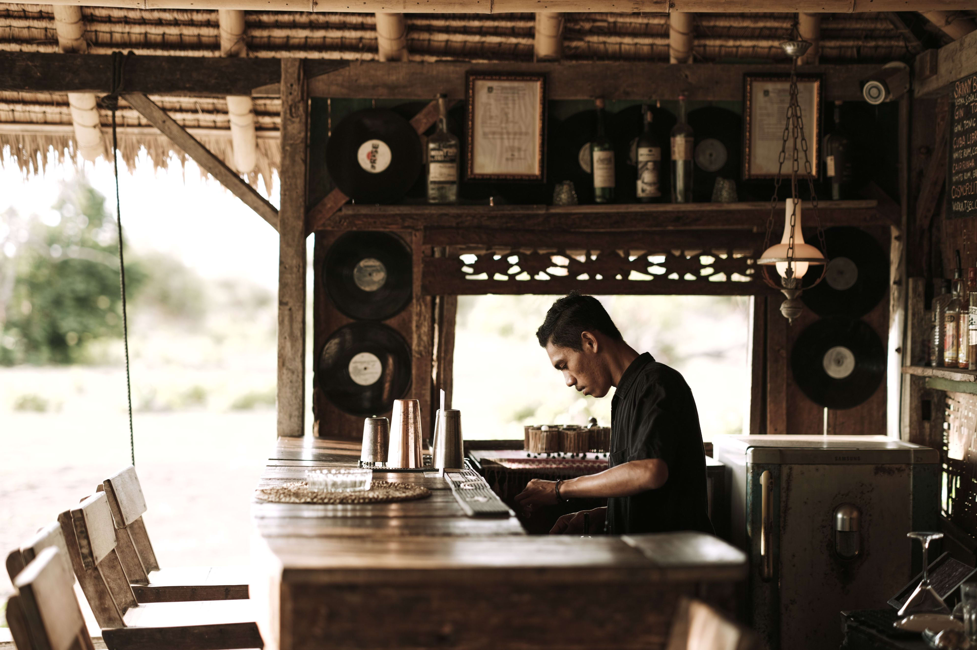 Nomi working behind the bar