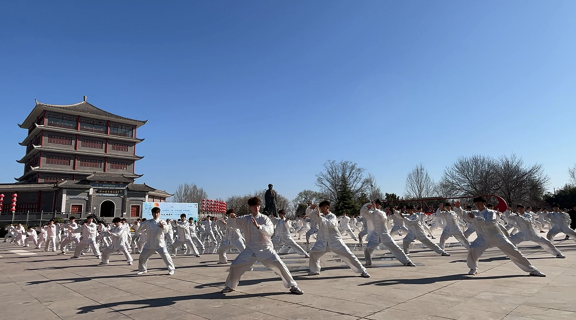 Group of students practicing Tai Chi in outdoor square
