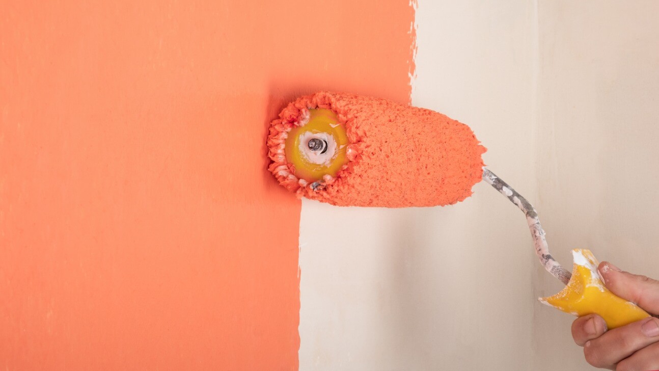 peach wall painting hand with roller the concept of