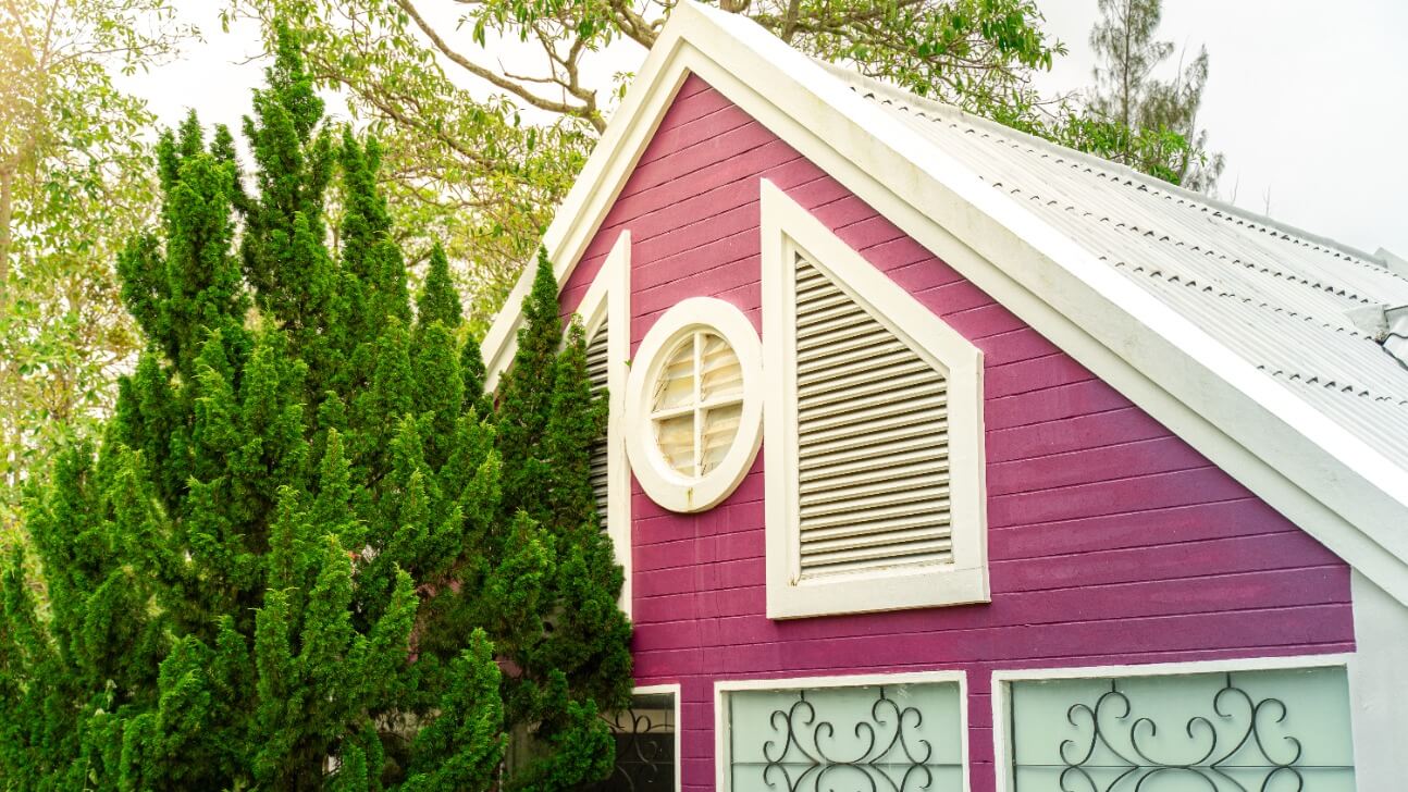 an english style house with purple walls windows beneath