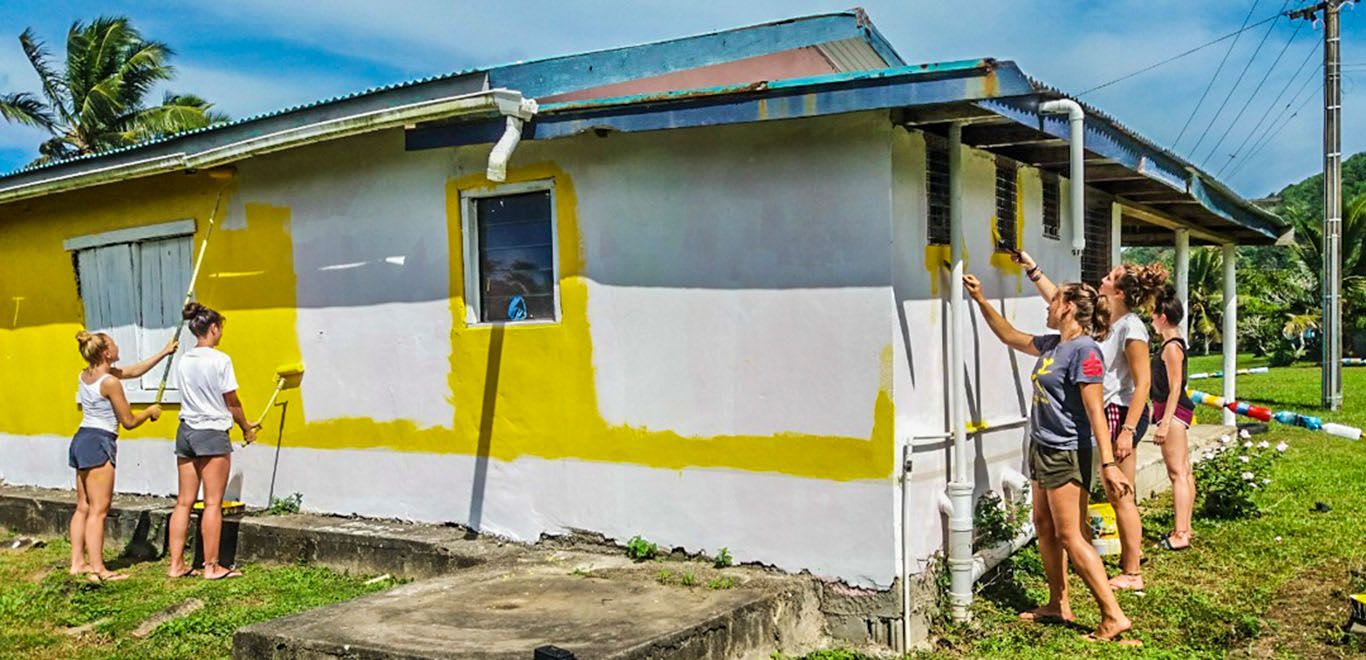 Volunteers painting a building in Fiji 