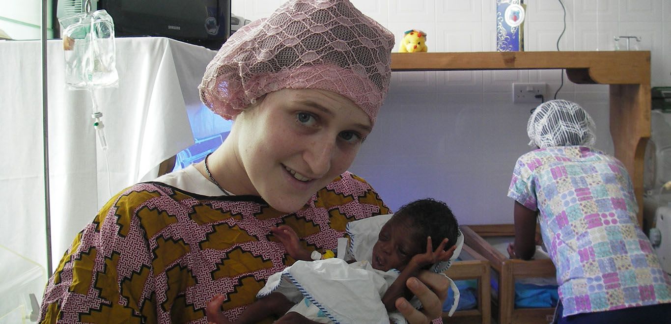 Women holding a baby in Ghana