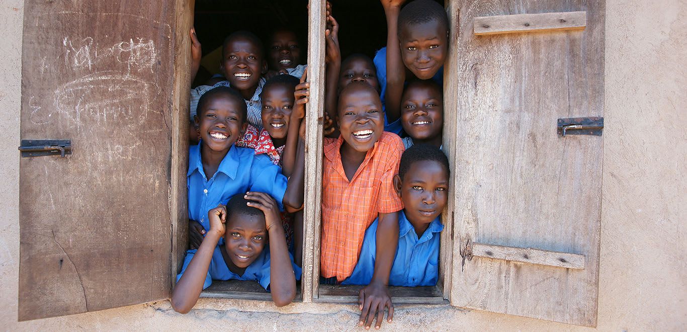 Kids in Kenya looking out of a window