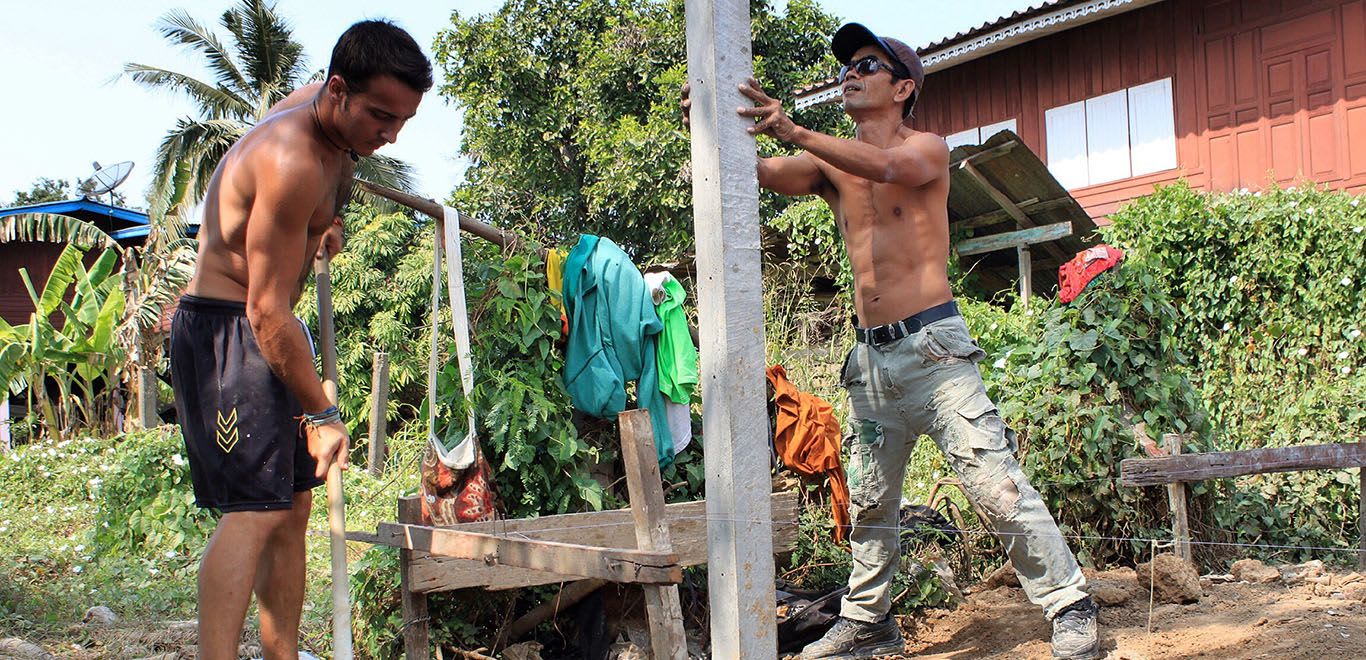 Men building a post in Thailand