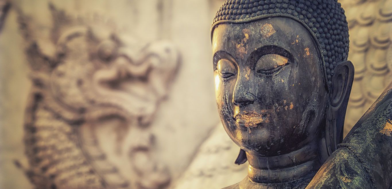 A Buddhist statue with a dragon in the background in Hua Hin, Thailand 