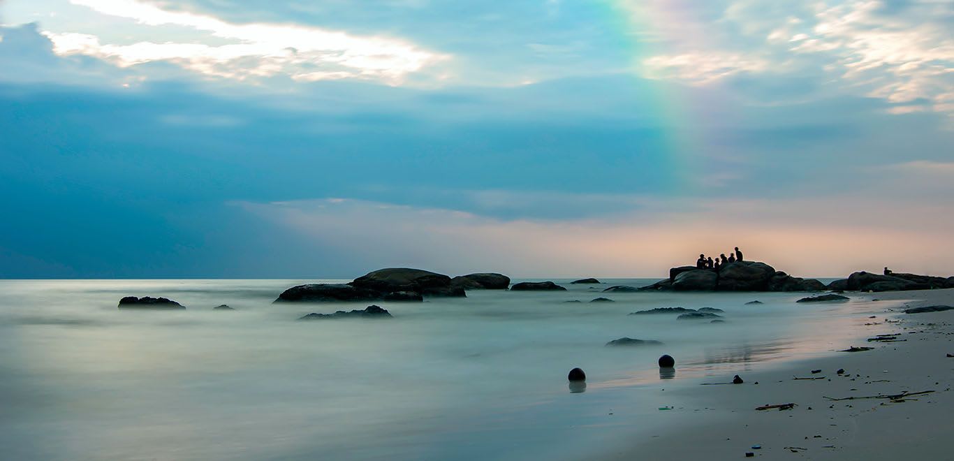 Young people enjoying the sunrise on Hua Hin beach, Thailand.