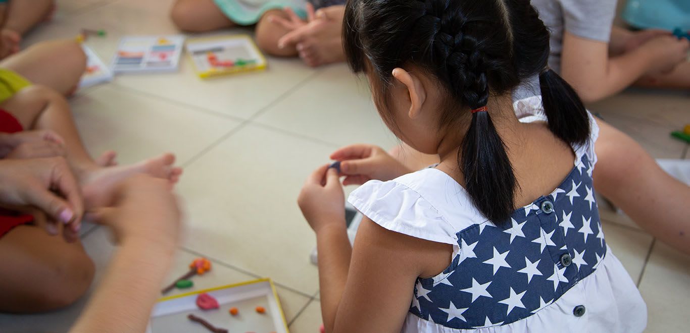 Child playing with Playdoh in Vietnam