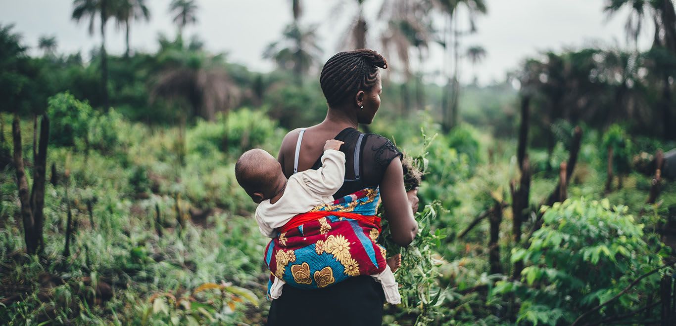 Woman with baby on farm