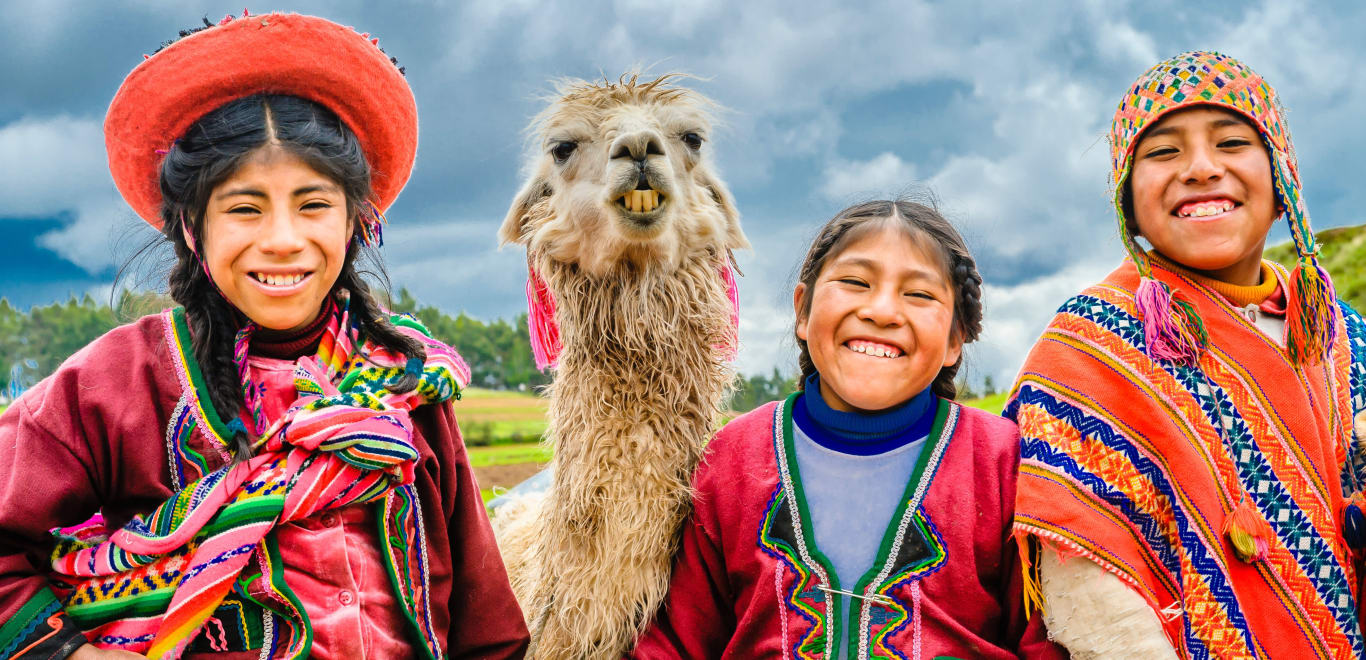 People smiling with llama Cusco, Peru