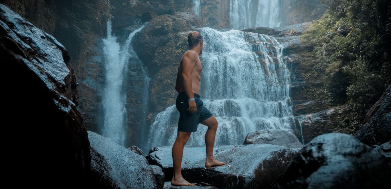 Man at Waterfall in Costa Rica