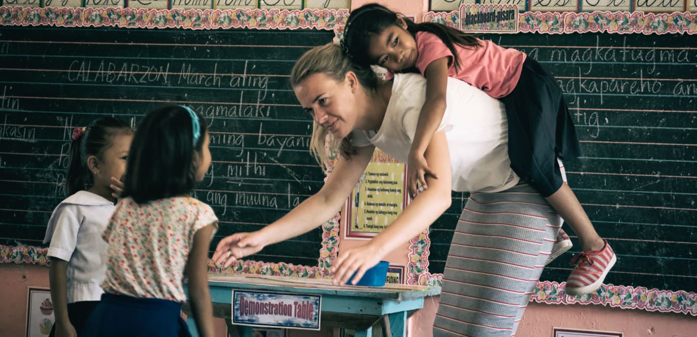 Teacher and kids playing in Palawan, Philippines