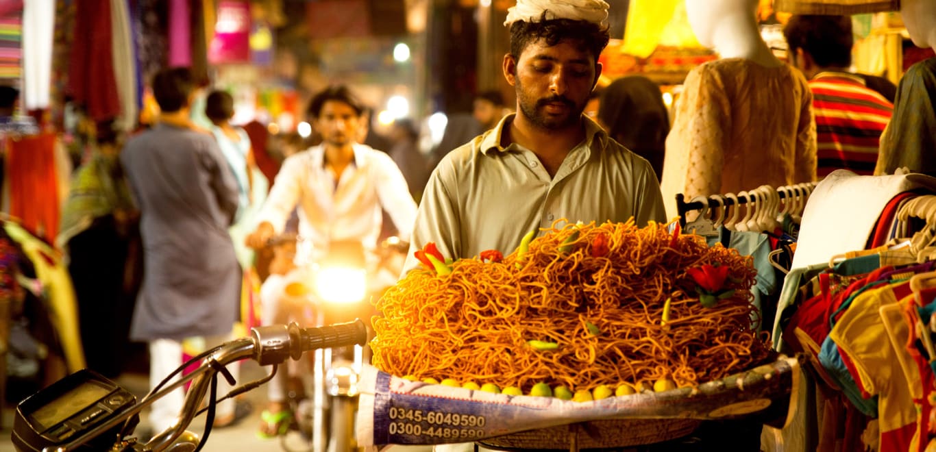 Night market with people and food vendors